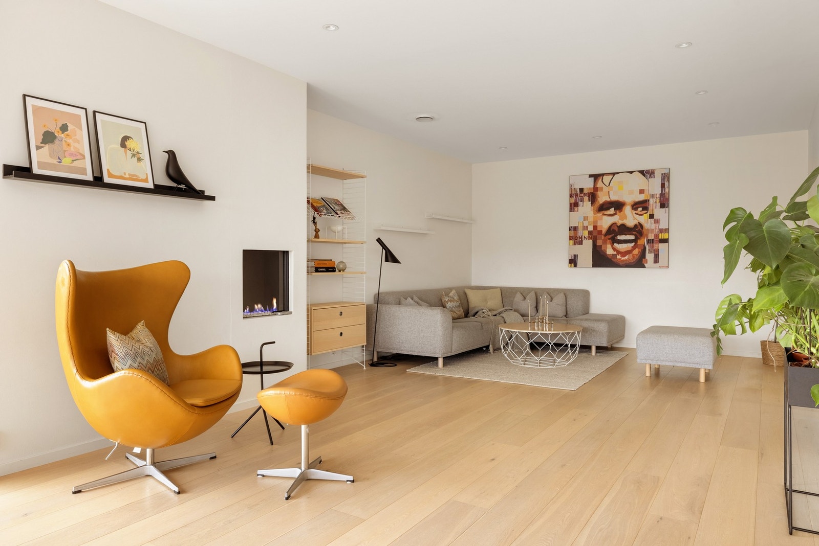 Rommets størrelse og planløsning lager god plass til å møblere i forskjellige soner. Legg merke til den lekre gasspeisen. Galleribilde