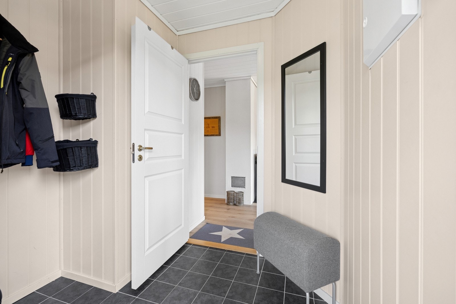 Fra overbygd inngangsparti kommer du inn i en romslig gang med varmekabler under fliser og lysmalte vegger. Gangen har god omkledningsplass og rom for garderobeløsninger Galleribilde