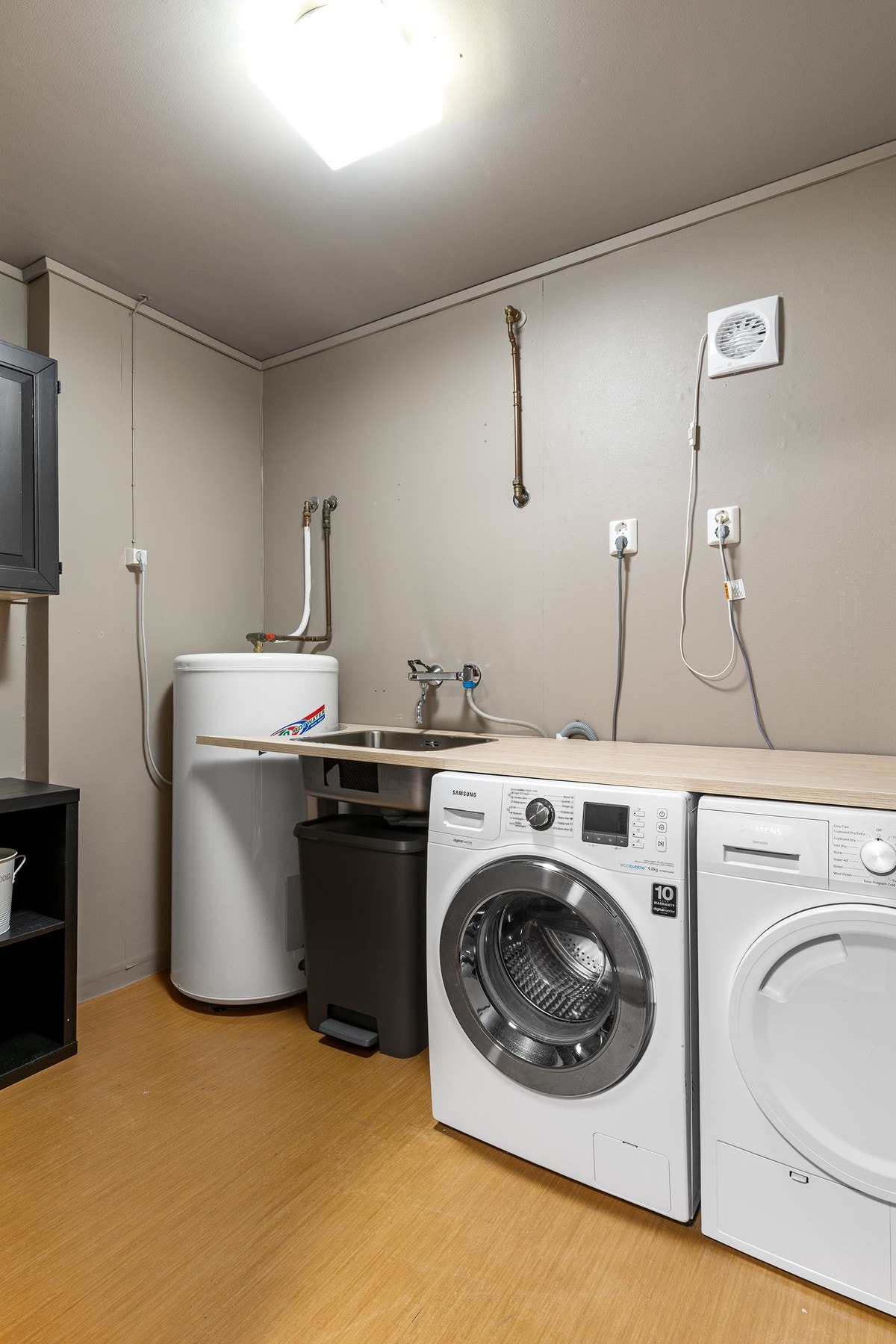 Boligens vaskerom er utstyrt med benkeplate med utslagsvask, opplegg for vaskemaskin samt plass til tørketrommel. Galleribilde