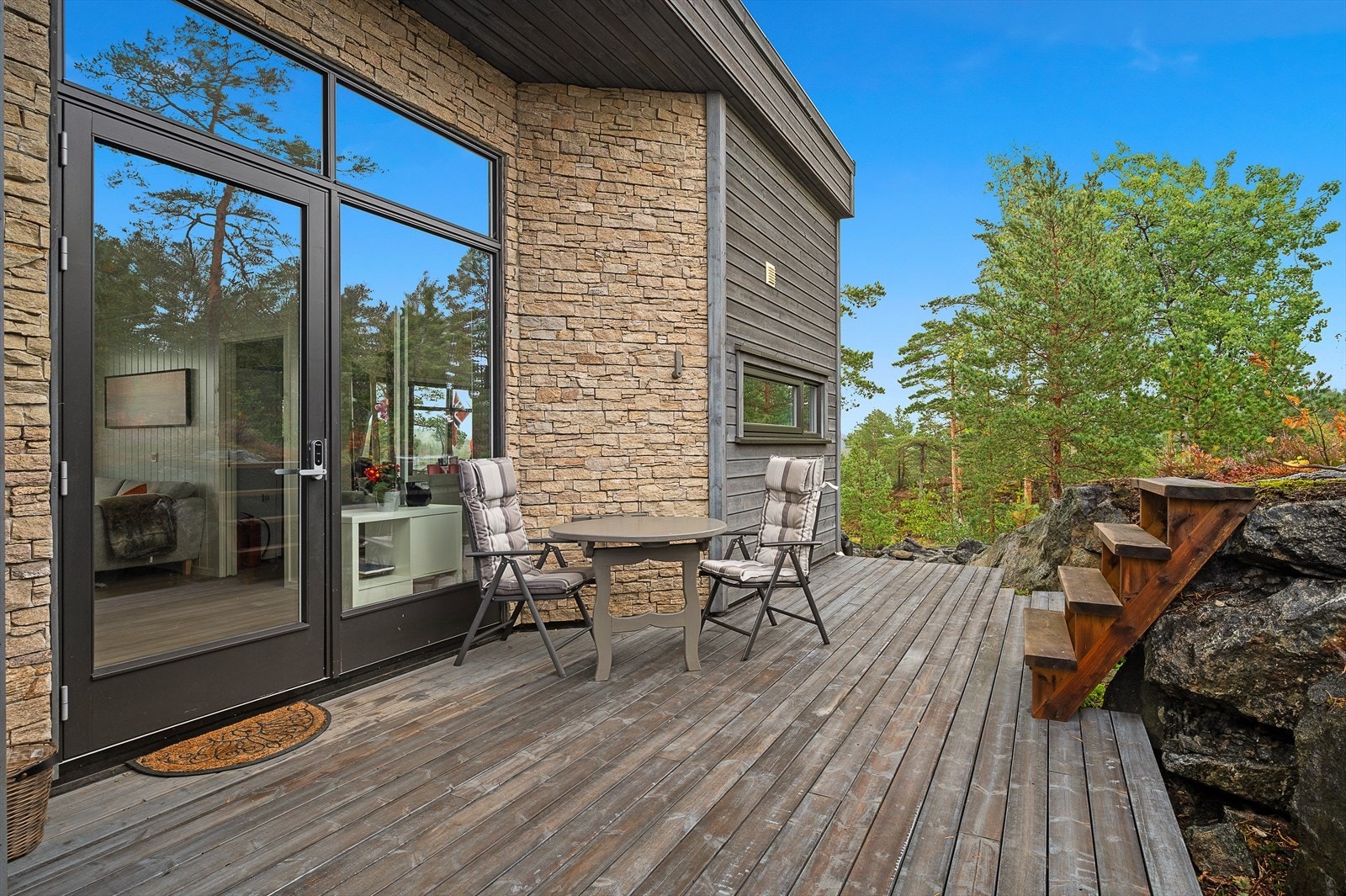 Inngangspartiet med store glassflater som slipper inn naturlig lys og natur. Galleribilde