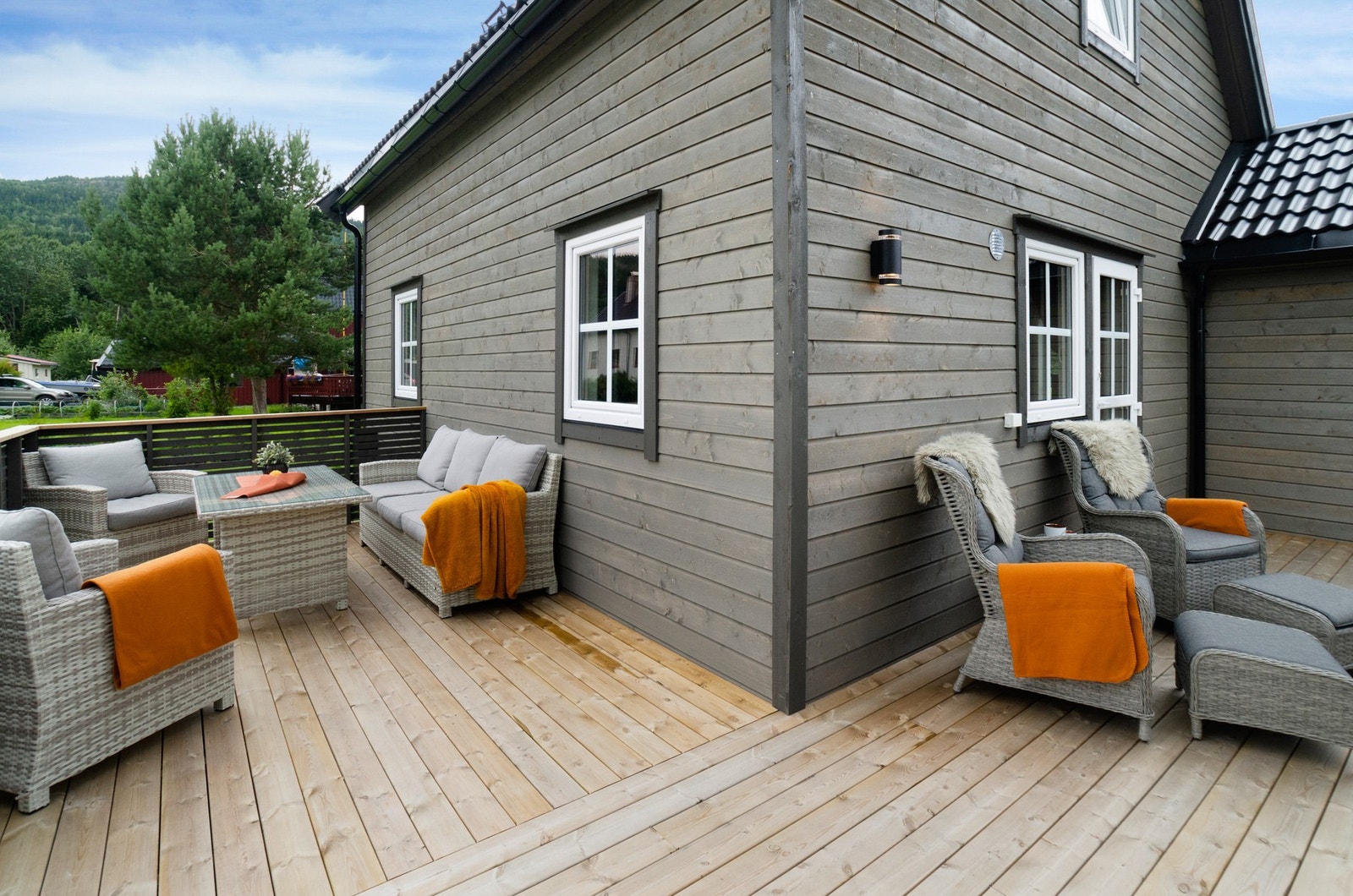 Terrasse fra 2023 med tredekke og gode solforhold, omkranset av stor hage. Galleribilde