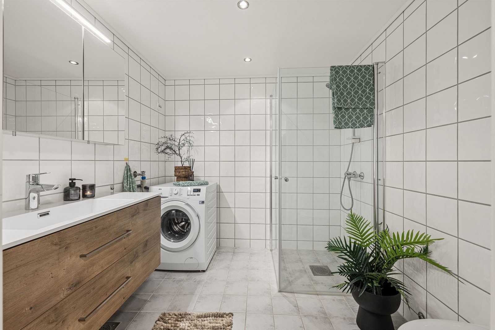 Badet er helfliset og har opplegg for vaskemaskin samt en praktisk dusjnisje. Galleribilde