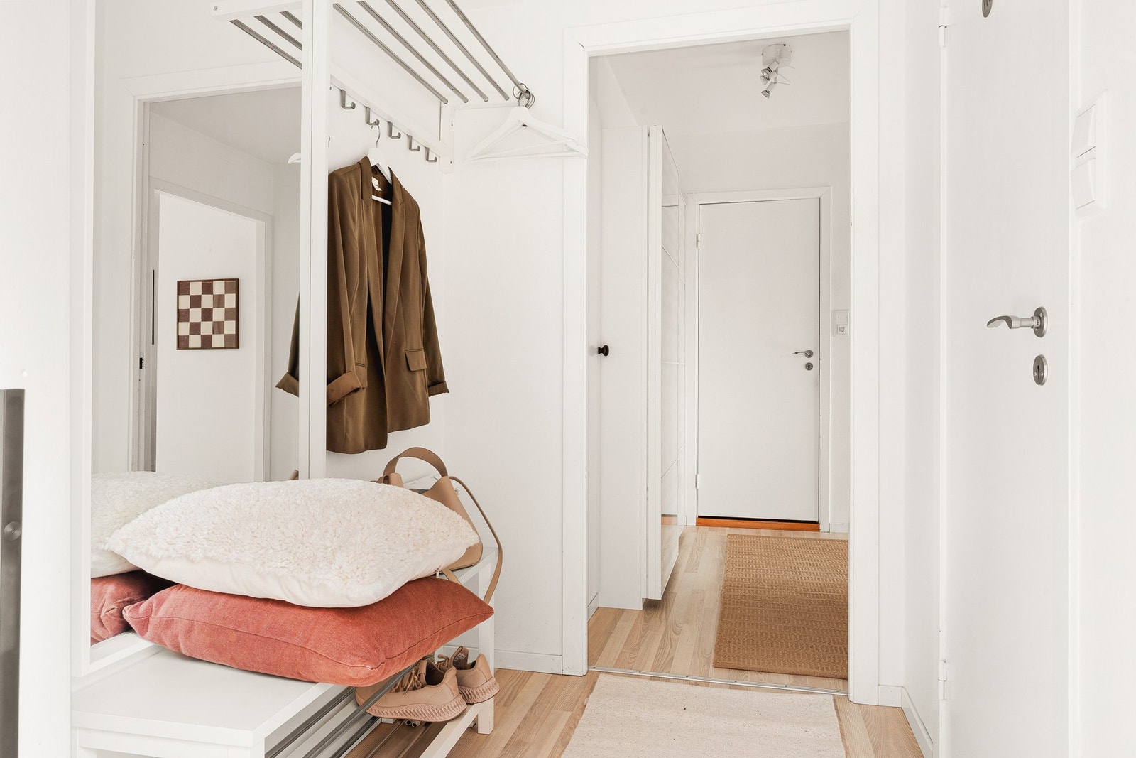 Fra entréen er beveger man seg videre inn i en større gang med oppbevaring i garderobe. Galleribilde