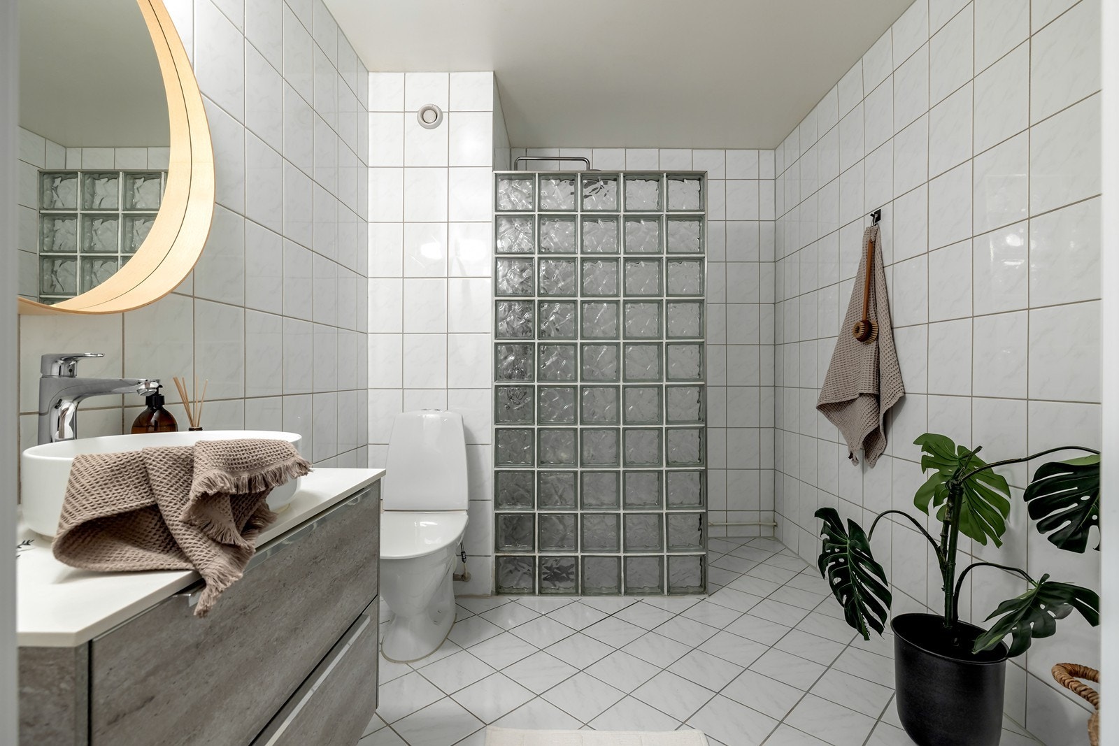 Badet har flislagt gulv med elektriske varmekabler og praktisk opplegg for vaskemaskin. Galleribilde