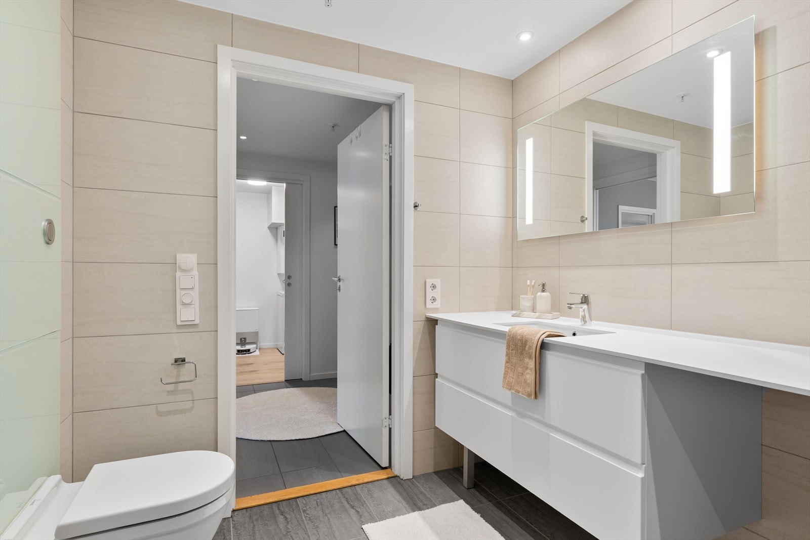 Det er også godt med oppbevaringsplass i den romslige baderomsinnredningen. Rommet belyses med downlights i himling og oppvarmes med gulvvarme. Galleribilde