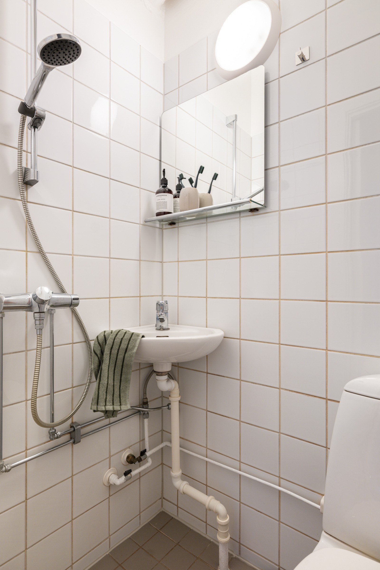 Leiligheten har et lyst flislagt baderom som har fått TG3 i tilstandsrapporten og må oppgraderes for å tåle normal bruk etter dagens krav. Galleribilde