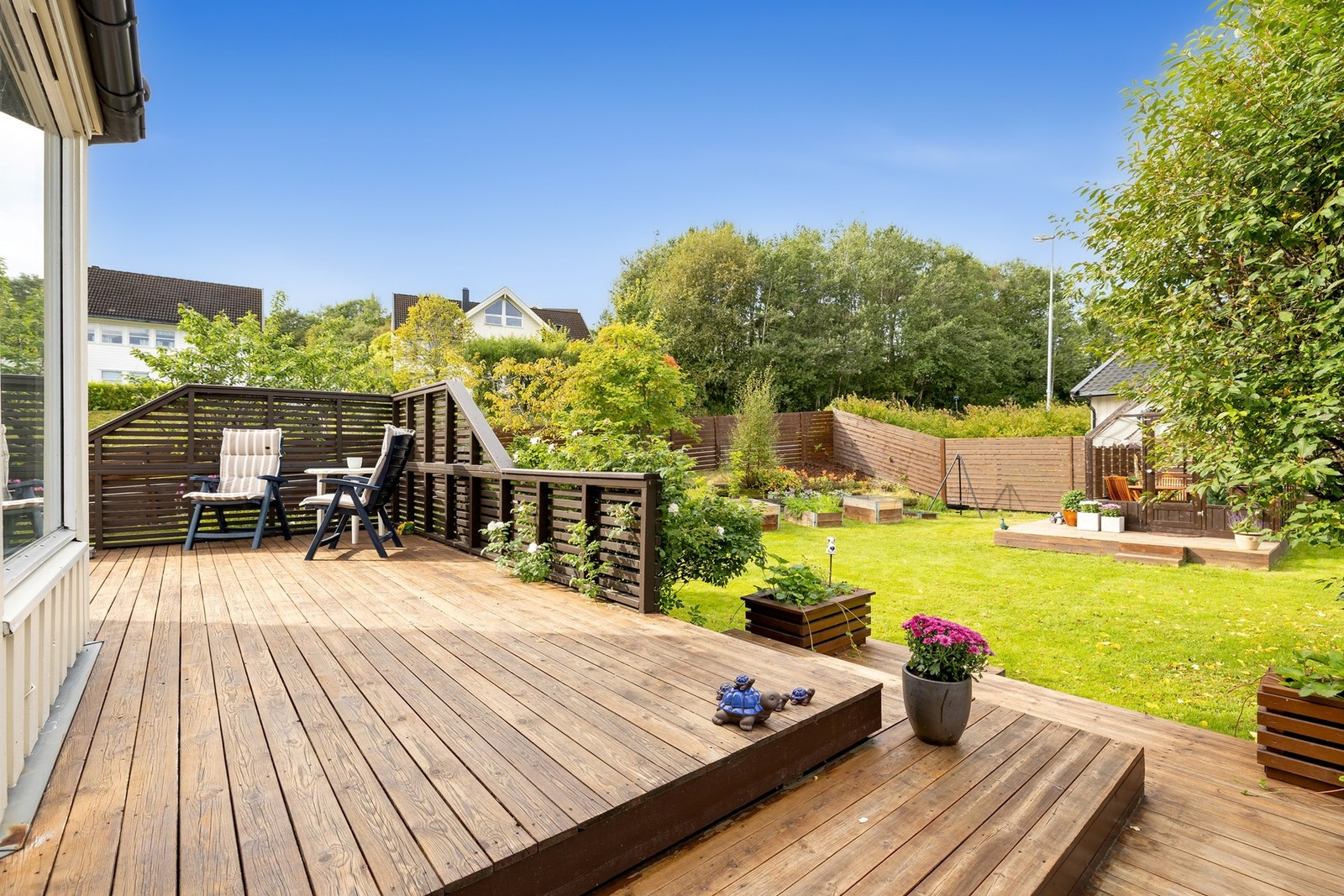 Terrasse på 66 kvm i trekonstruksjoner som er etablert på bakkenivå og understøttet med pilarer/stolper i tre på støpte pilarer/fundamenter hvor gulvet er belagt med impregnerte terrassebord og rekkverk er oppført i treverk. Tilkomst fra stue. Galleribilde