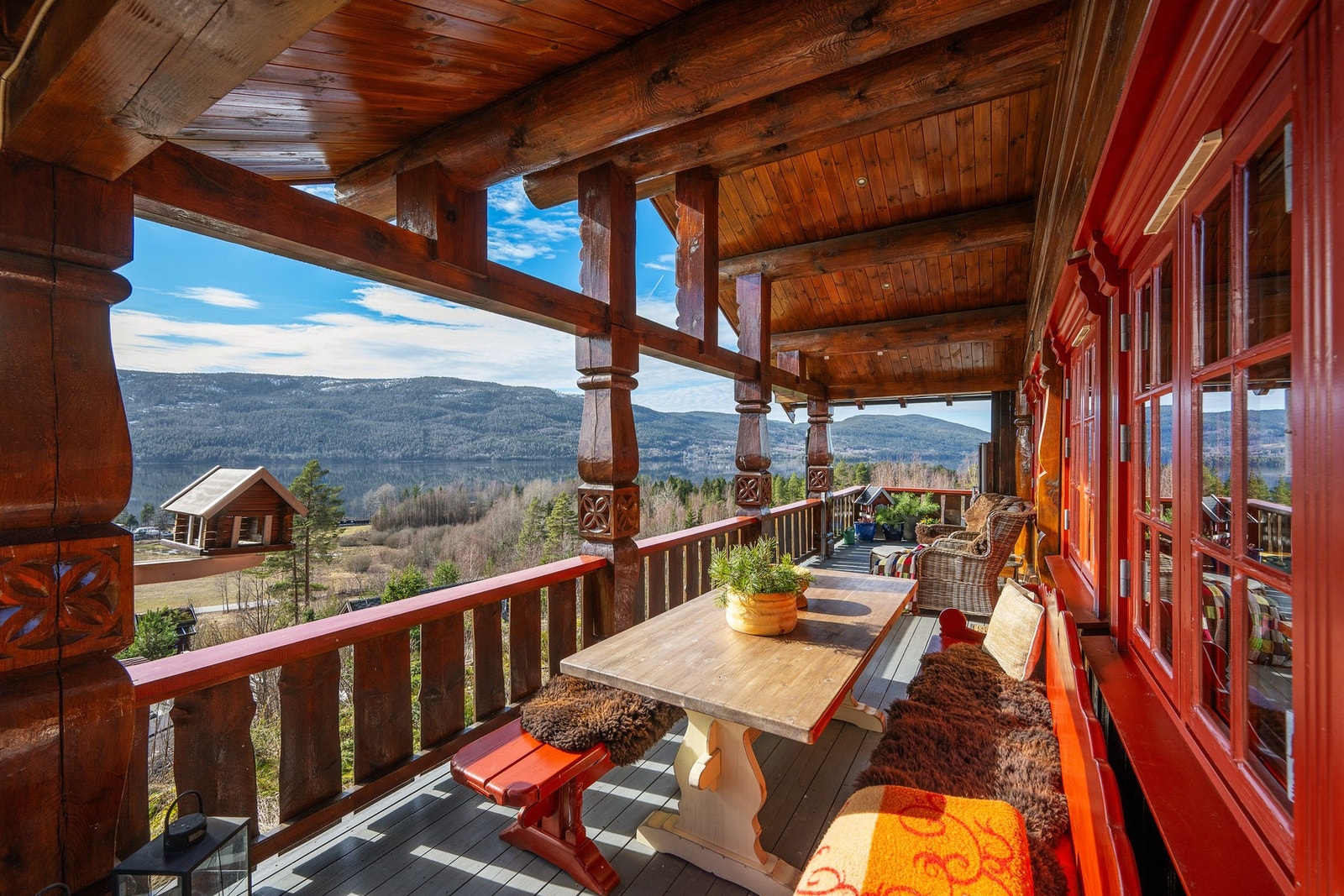 Stor og solrik veranda med god plass for sitteplasser - perfekt for lange dager ute med fantastisk utsikt over vann og fjell. Galleribilde