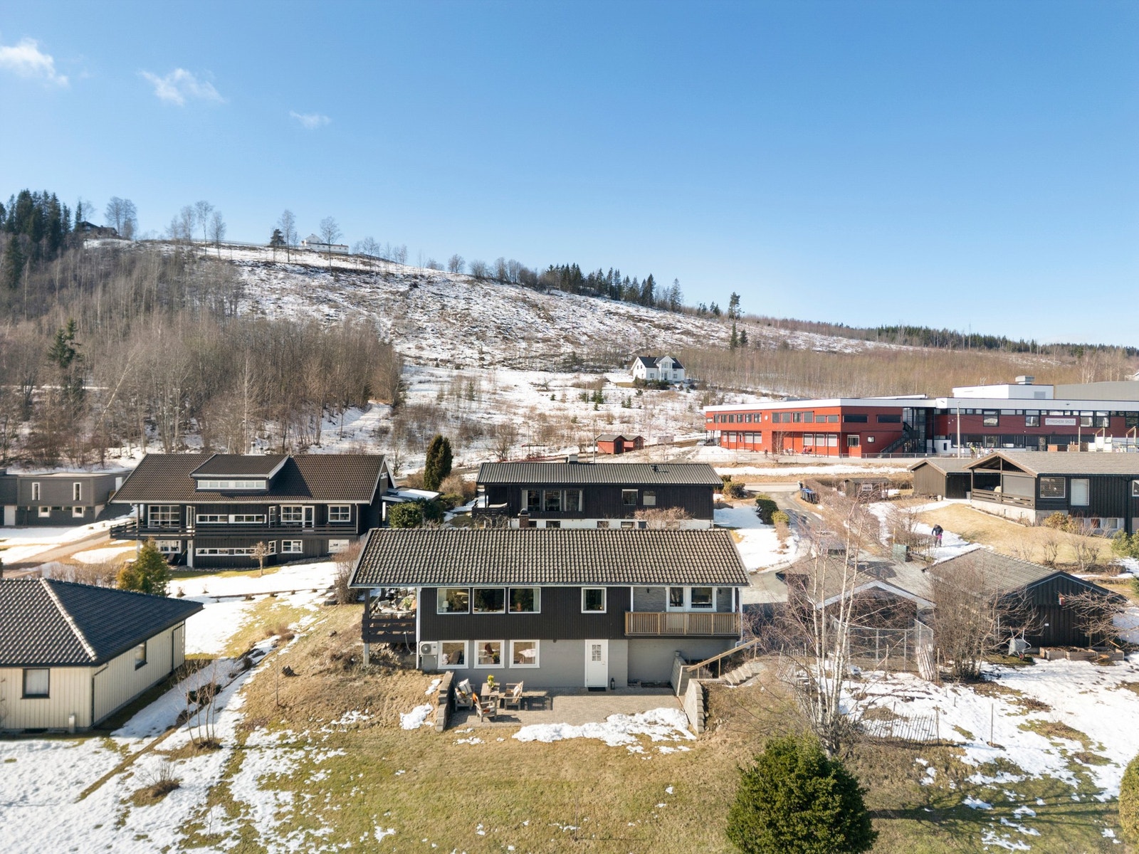 Bildet viser nærområdet med boliger, skole og naturomgivelser. Galleribilde