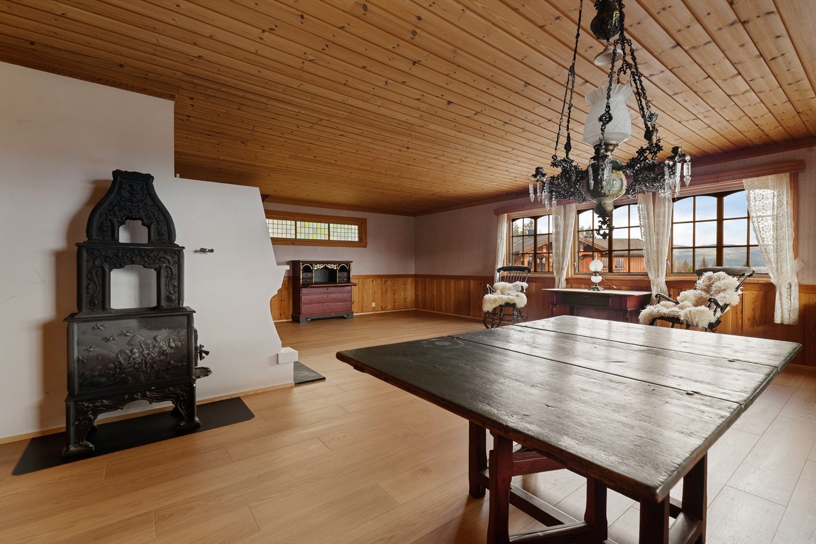 Boligen har en stor stue med både åpen peis og vedovn. Galleribilde