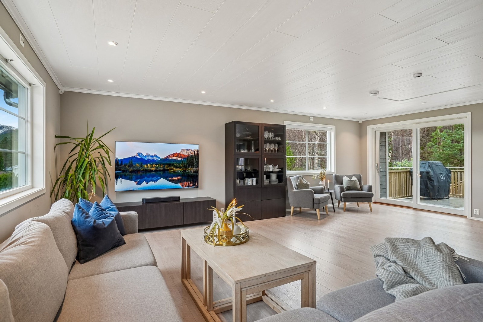 Her kan familien samles i sofakroken, og sommerdager er det stor skyvedør direkte til terrassen. Galleribilde