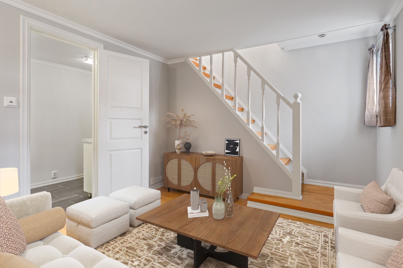 Nydelig hvitmalt trapp med eiketrinn ned til innredet rom med eikeparkett på gulv. Digitalt innredet, rommet fremstår tomt Galleribilde