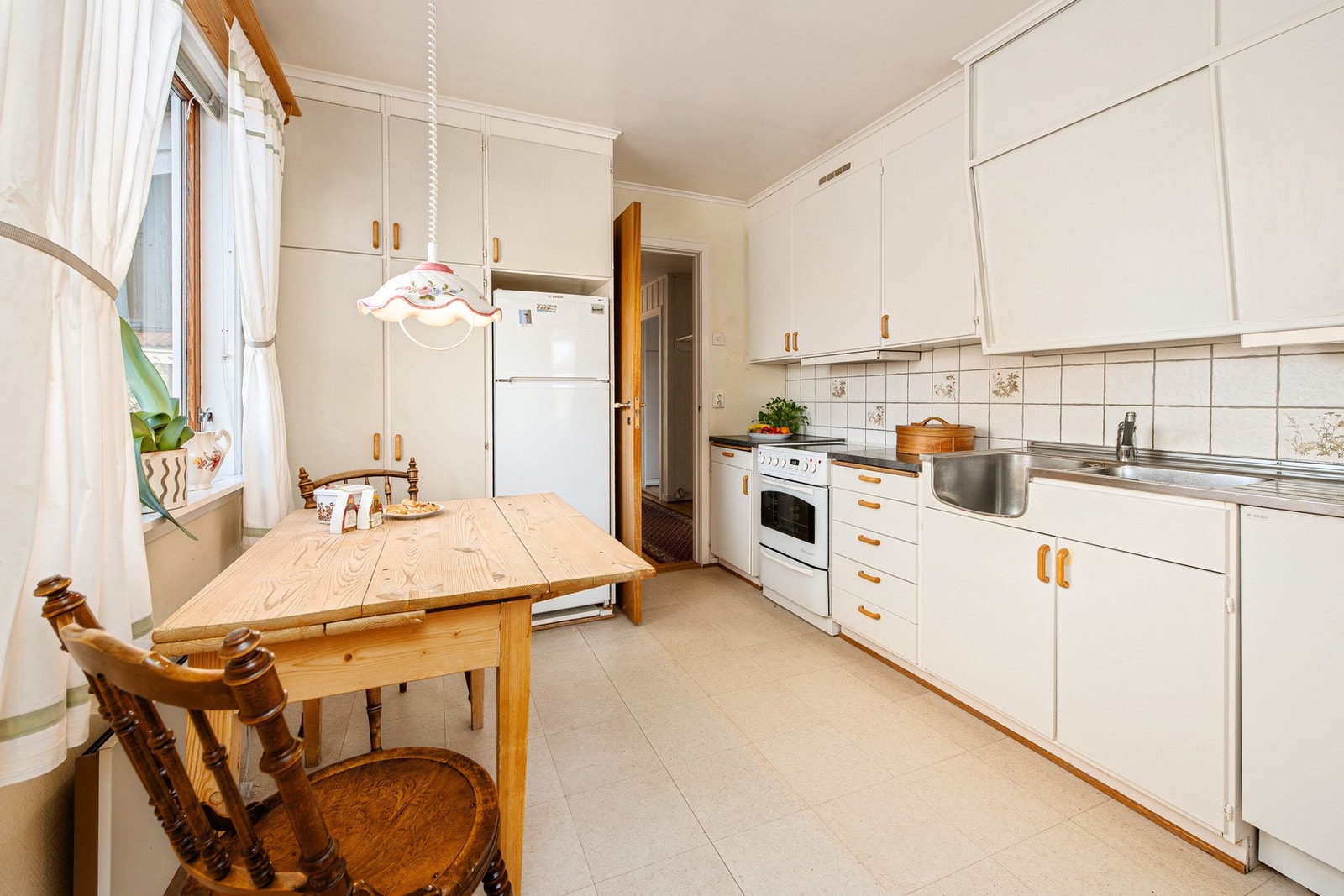 Kjøkken med eldre kjøkkeninnredning. Tilgang til kjøkken både fra gang og stue Galleribilde