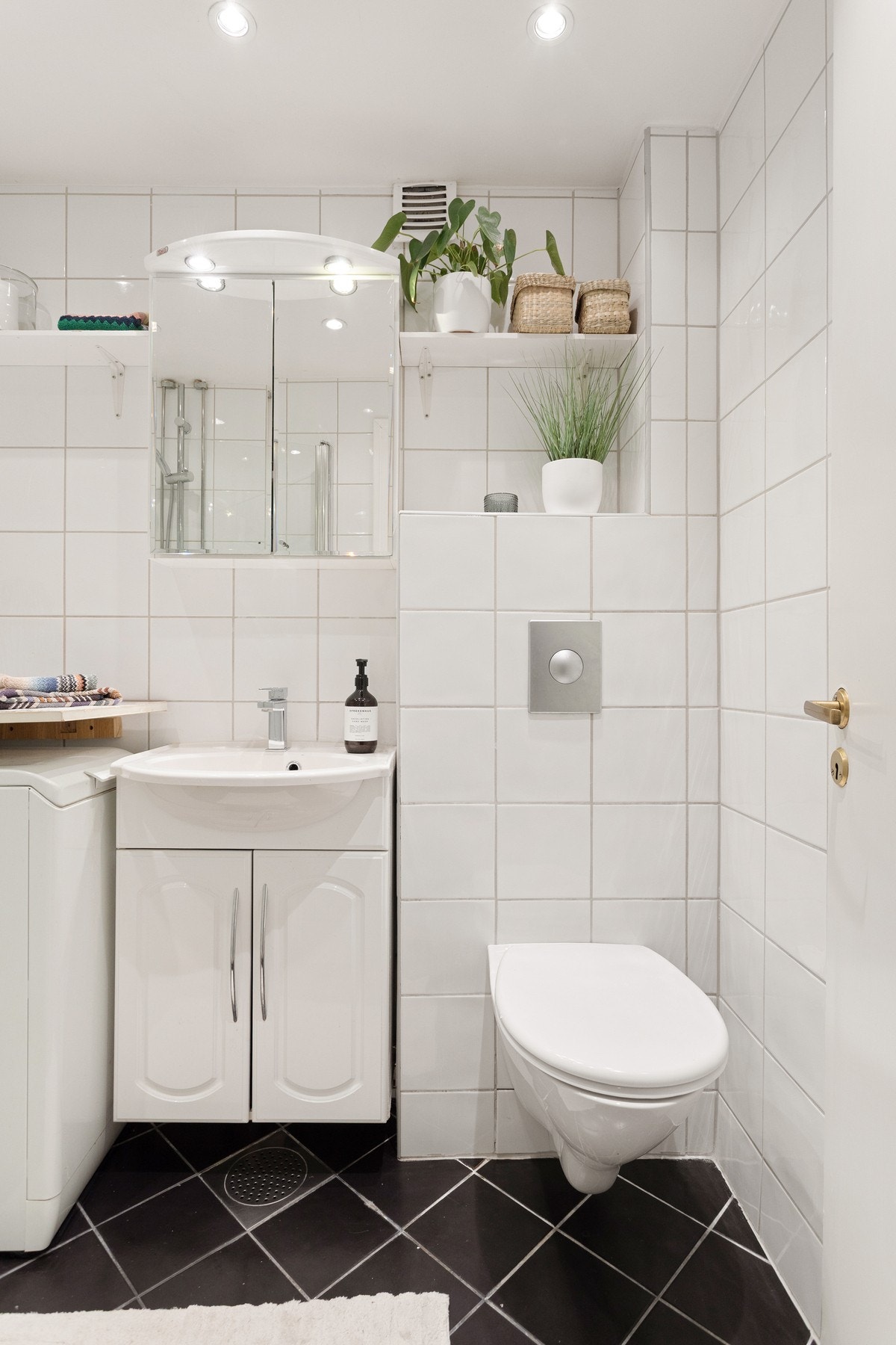 Badet er utstyrt med innredning med skap og servant, speilskap med belysning over, vegghengt toalett og dusj med innfellbare dusjdører som frigjør plass på gulvet. Galleribilde