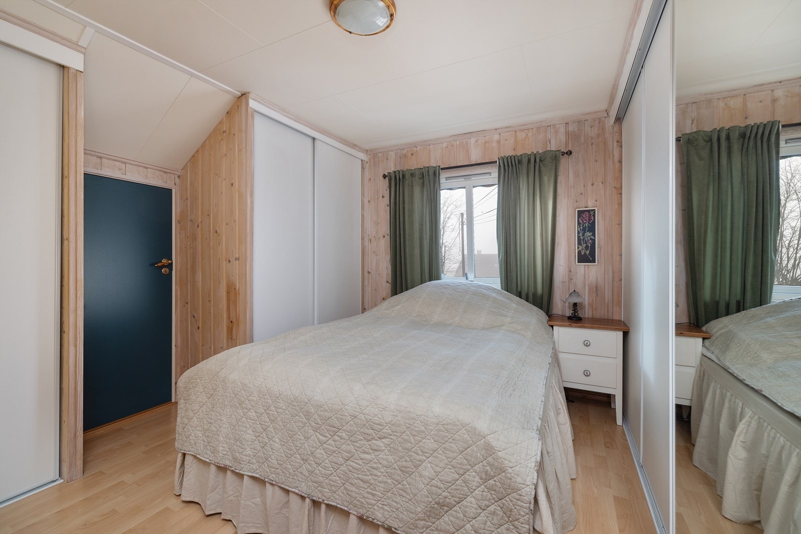 Rommet har plassbygde garderobeløsninger og laminat på gulvet. Galleribilde