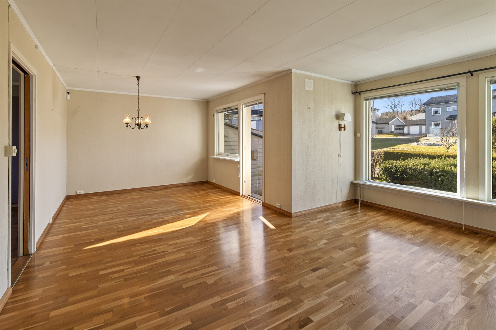 Stuen har god plass til både sittegruppe og spisebord, med eikeparkett på gulvet. Galleribilde