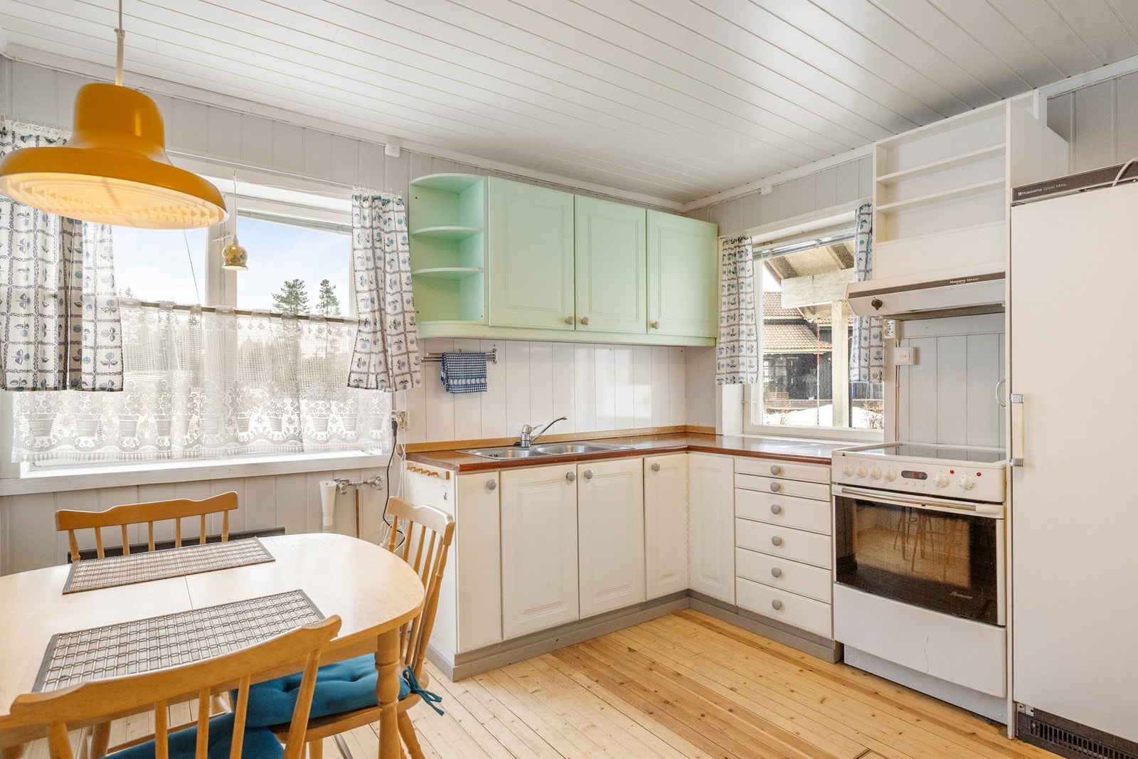 Kjøkkenet har eldre innredning med profilerte fronter, benkeplate med nedfelt vask samt plass til komfyr og kjøleskap Galleribilde