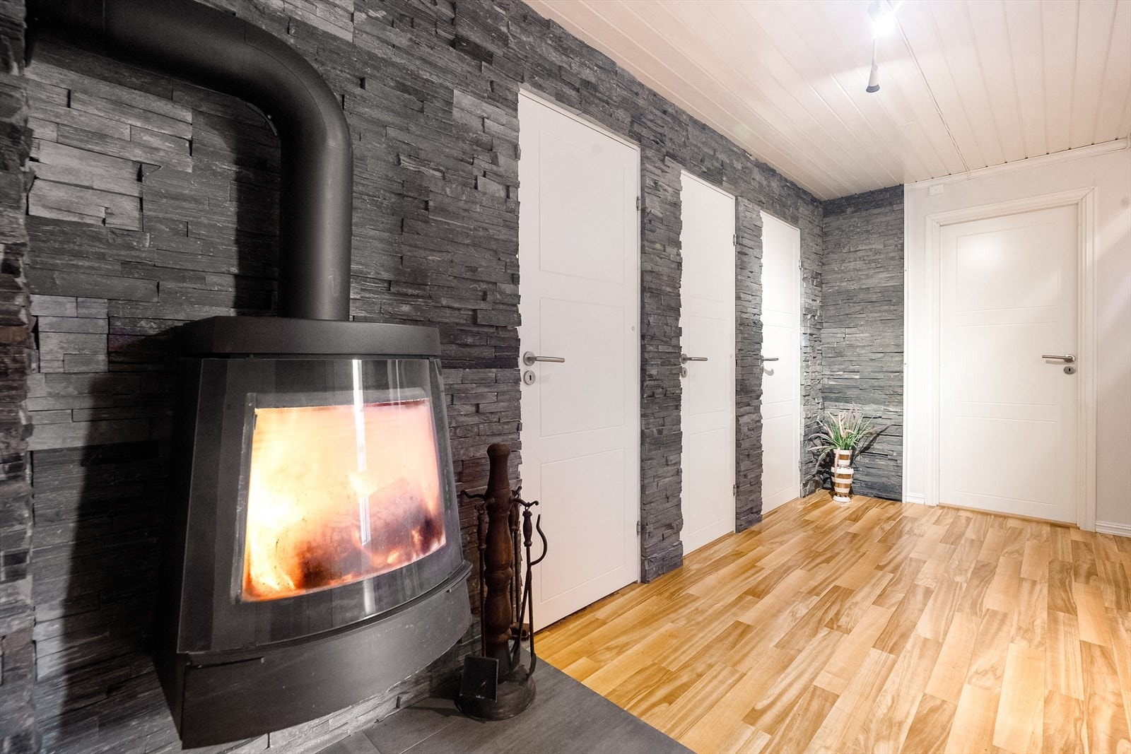 Fra entre er det inn i en pen gang hvor det er montert vedovn for ekstra varme vinterstid. Galleribilde