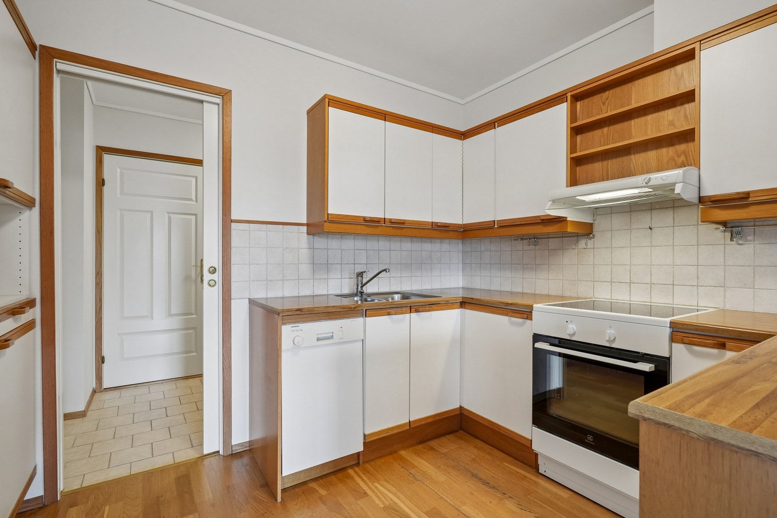 Det er benkeplate av laminat, god benkeplass og fliser på vegg over benk. Galleribilde