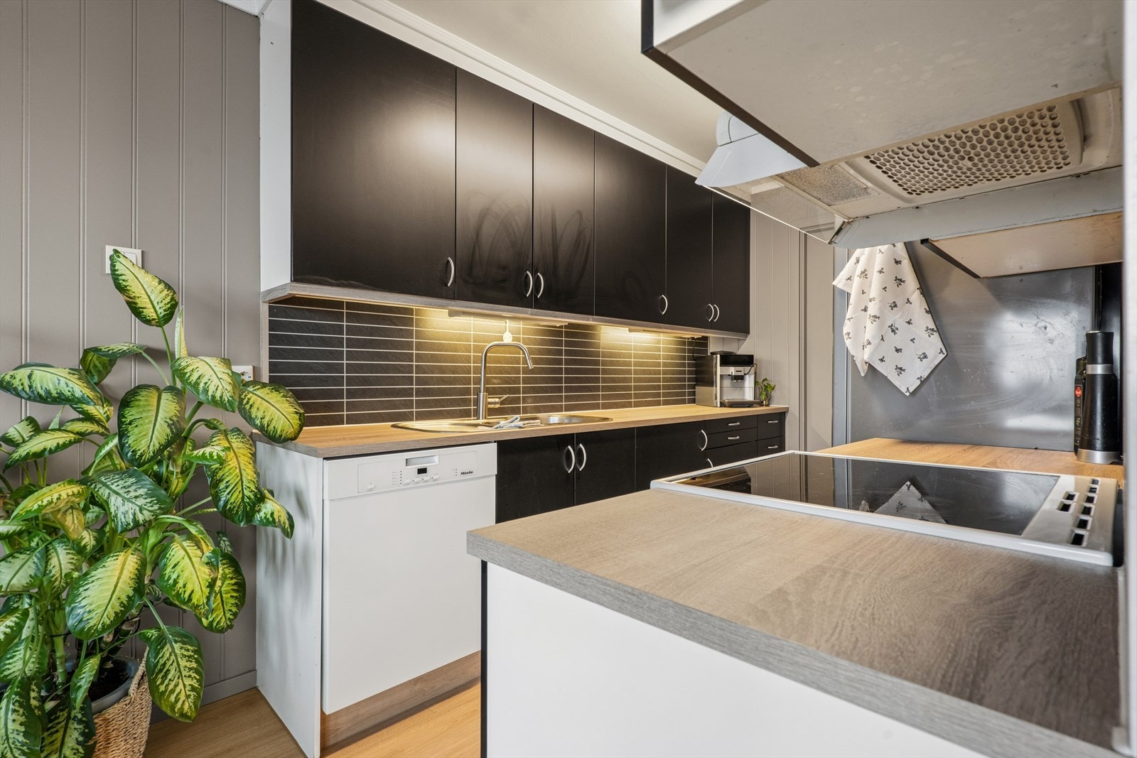 Kjøkkenet har glatte folierte fronter og laminatbenkeplate. Galleribilde