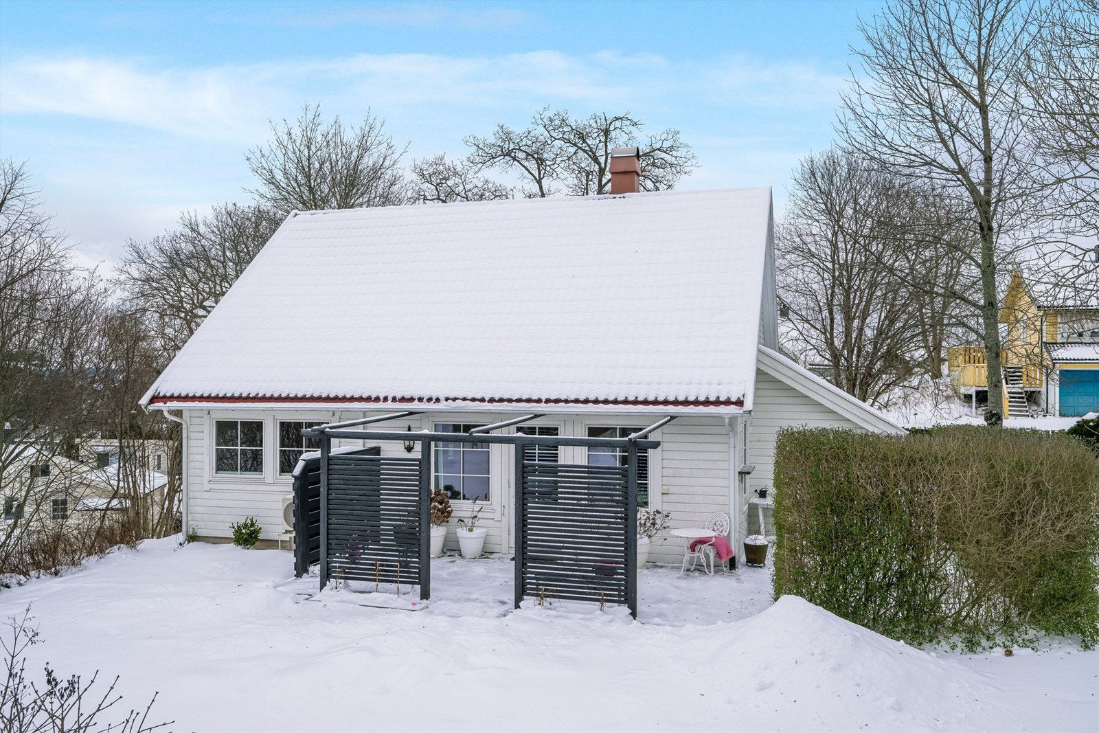 Nyt avslapping på en solrik terrasse med skjerming, rett utenfor stuen. Galleribilde