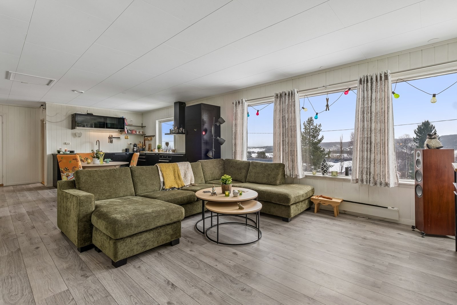 Den åpne løsningen mellom stue og kjøkken skaper et sosialt og luftig allrom. Rikelig med lysinnslipp og utsikt. Galleribilde