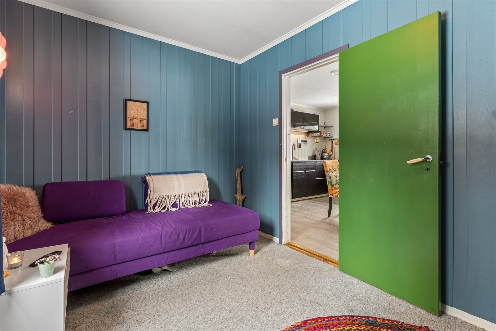 Boligens andre soverom i hovedetasjen, med teppegulv og malte panelvegger. Galleribilde