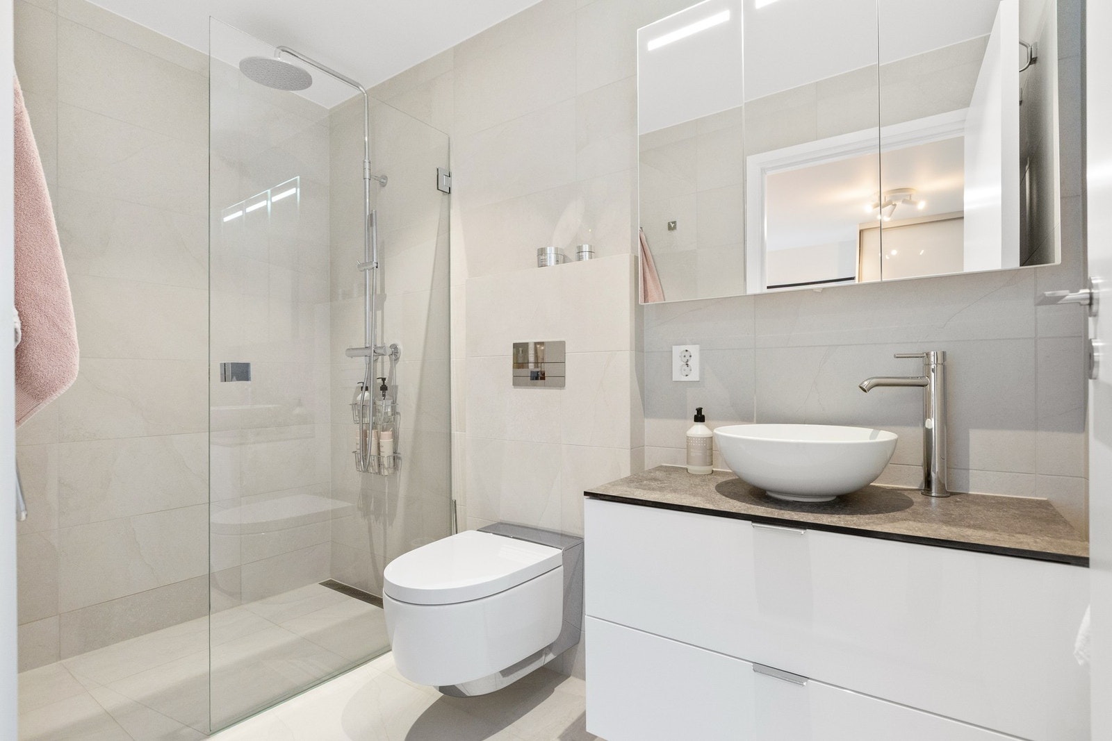 Etasjens andre bad har lekker og tidløs utførelse, samt gulvvarme og regnfallsdusj. Galleribilde