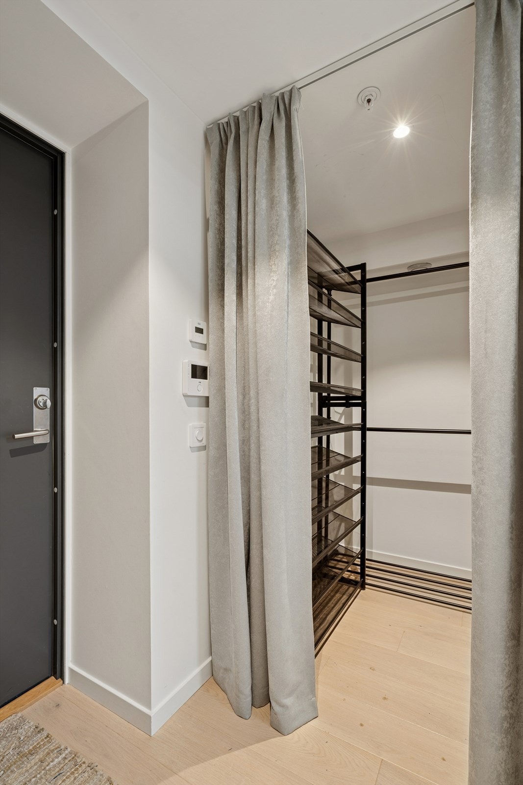 Praktisk skjult nisje i entre skjult bak pen gardin-løsning. Galleribilde