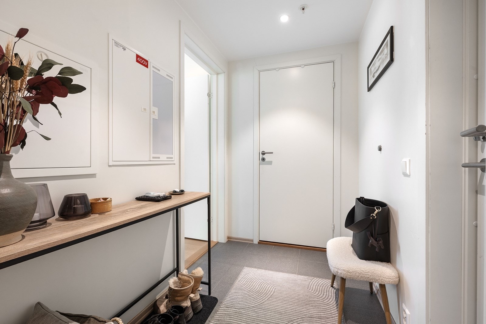 Lys og innbydende entré med downlights i himlingen og flislagt gulv. Galleribilde