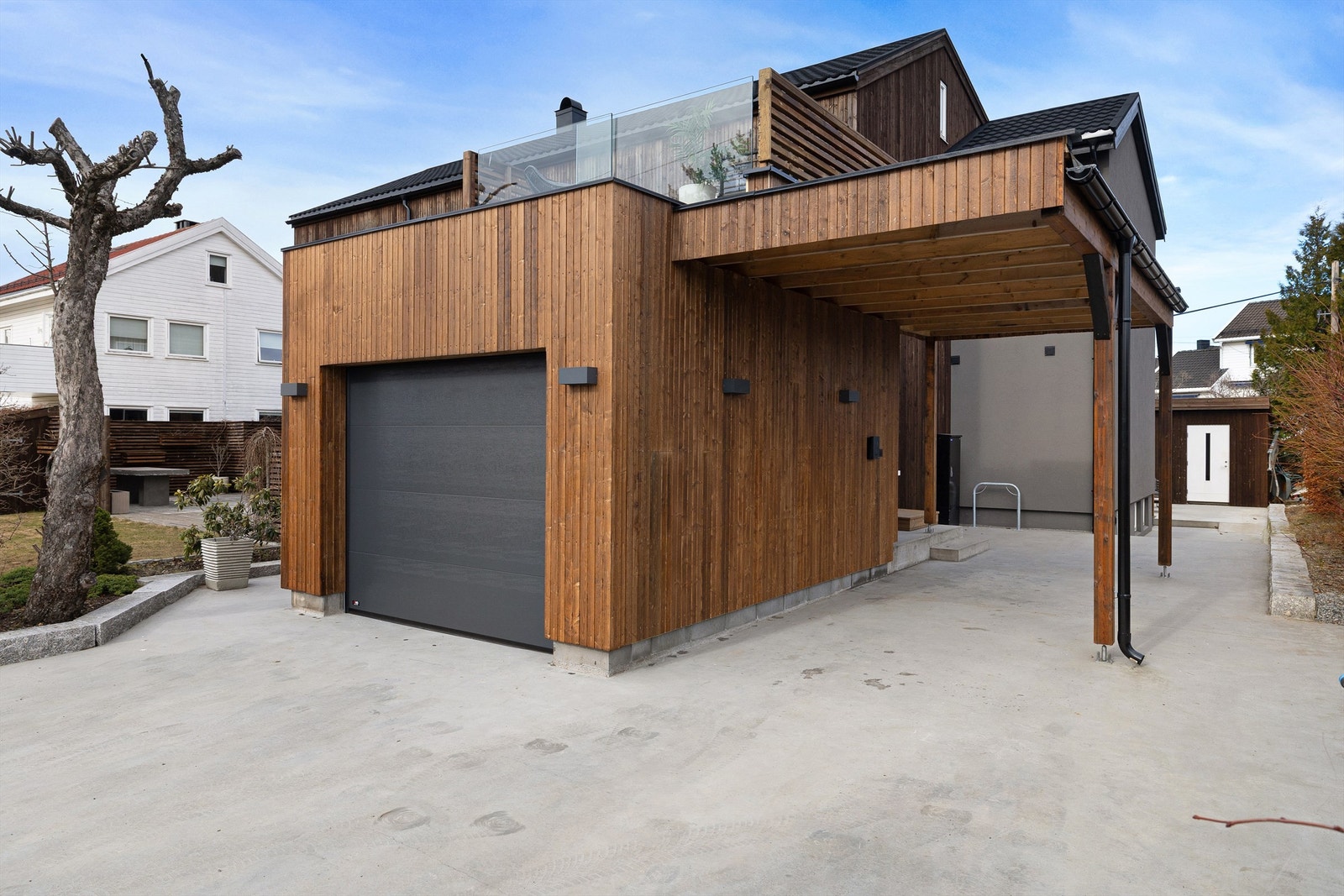 Biloppstillingsplass til en bil i carport, samt oppstillingsplass foran carport. Det er installert ladeboks i carporten Galleribilde