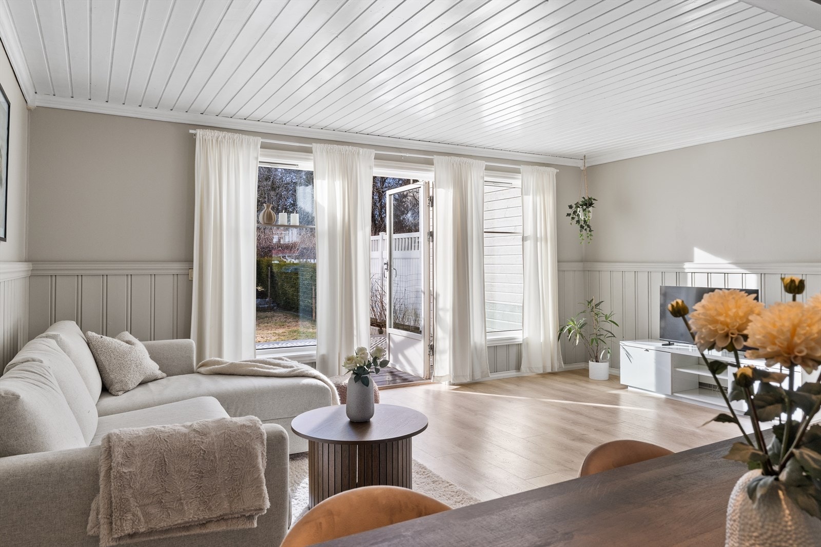 Stuen er lys og luftig, med rikelig plass for både sofa, spisebord og oppbevaring Galleribilde