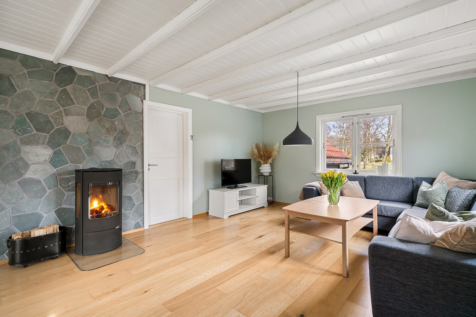 Store vindusflater fyller rommet med naturlig lys. Galleribilde