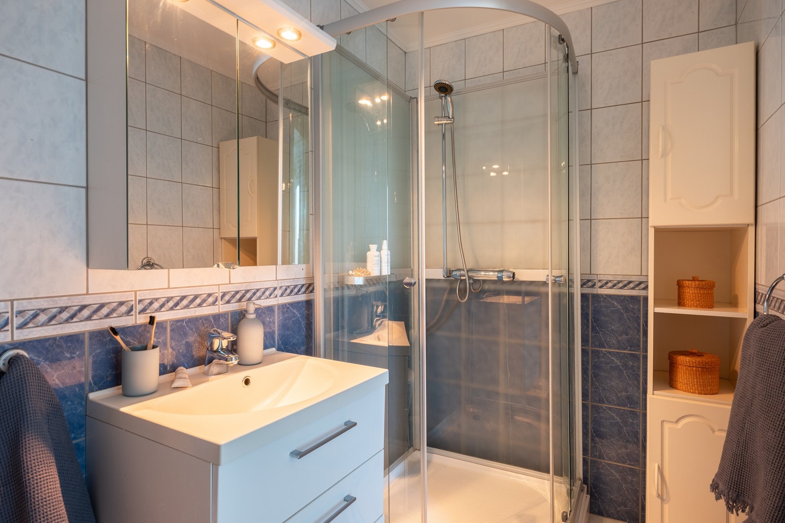 Badet i sokkeletasjen har innredning med servant, dusjkabinett, høyskap og toalett. Galleribilde