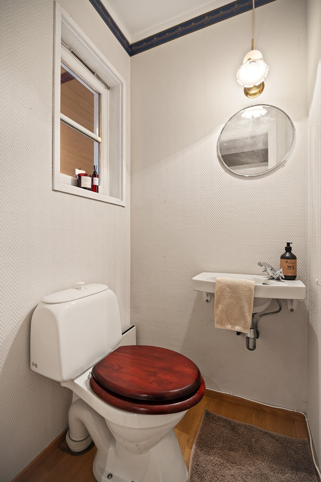 Praktisk wc rom med servant og parkett på gulvet med adkomst fra entré. Galleribilde