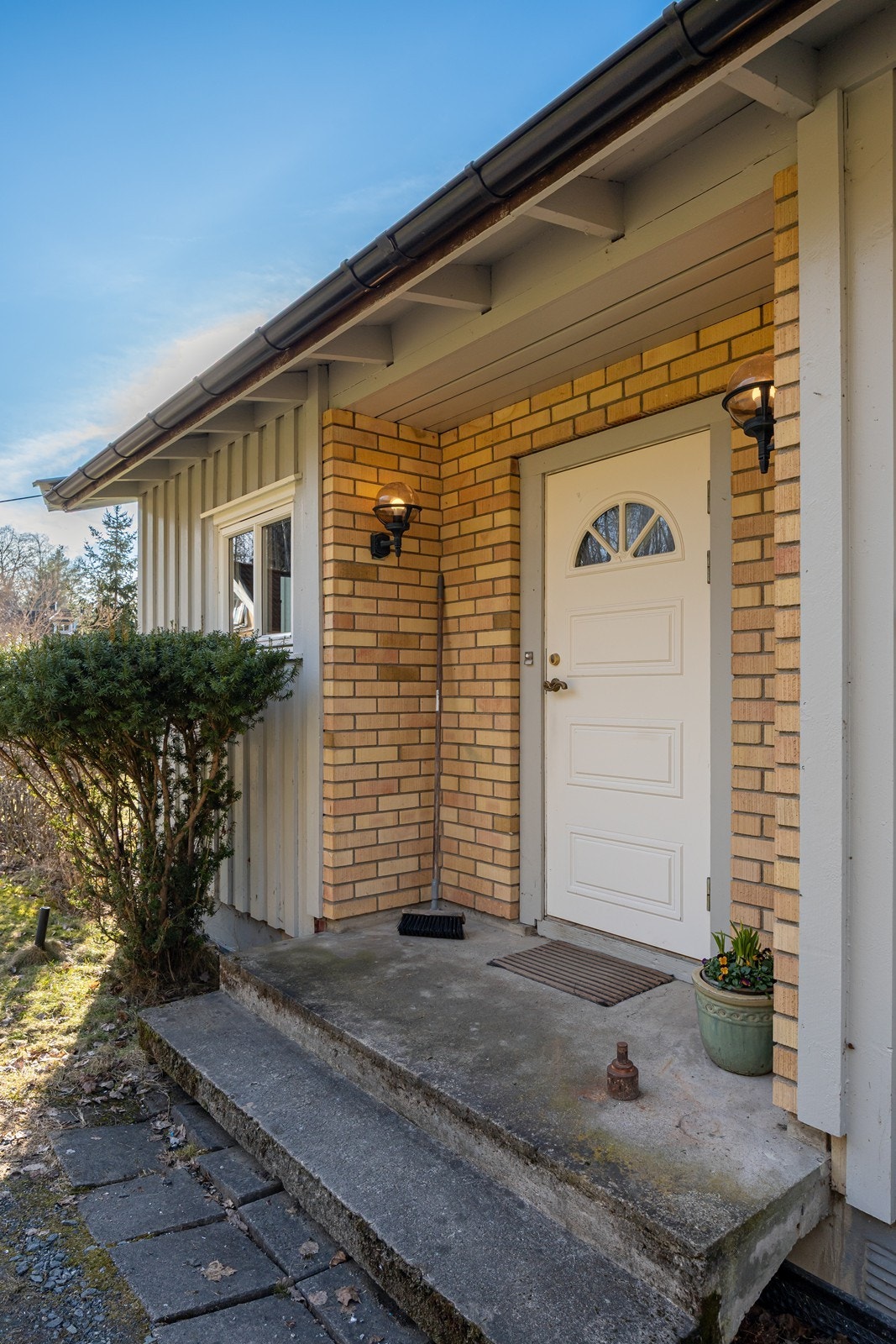 Hovedhusets inngangsparti er praktisk overbygd og utstyrt med belysning, samt ringeklokke. Galleribilde