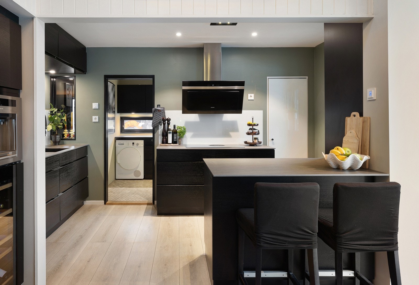 Praktisk kjøkkenøy gir ekstra arbeidsflate og sitteplasser, og bidrar til en naturlig overgang mot spisestuen. Galleribilde