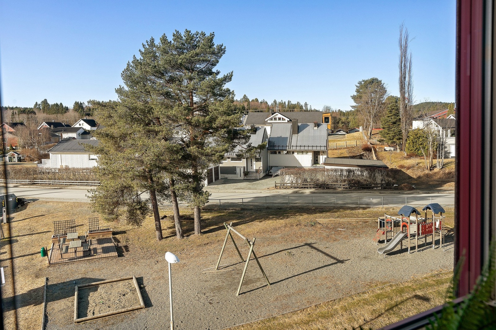 Fra kjøkkenvinduet har du god oversikt over lekeplassen hvor barna kan leke - enkelt å rope inn til middag Galleribilde