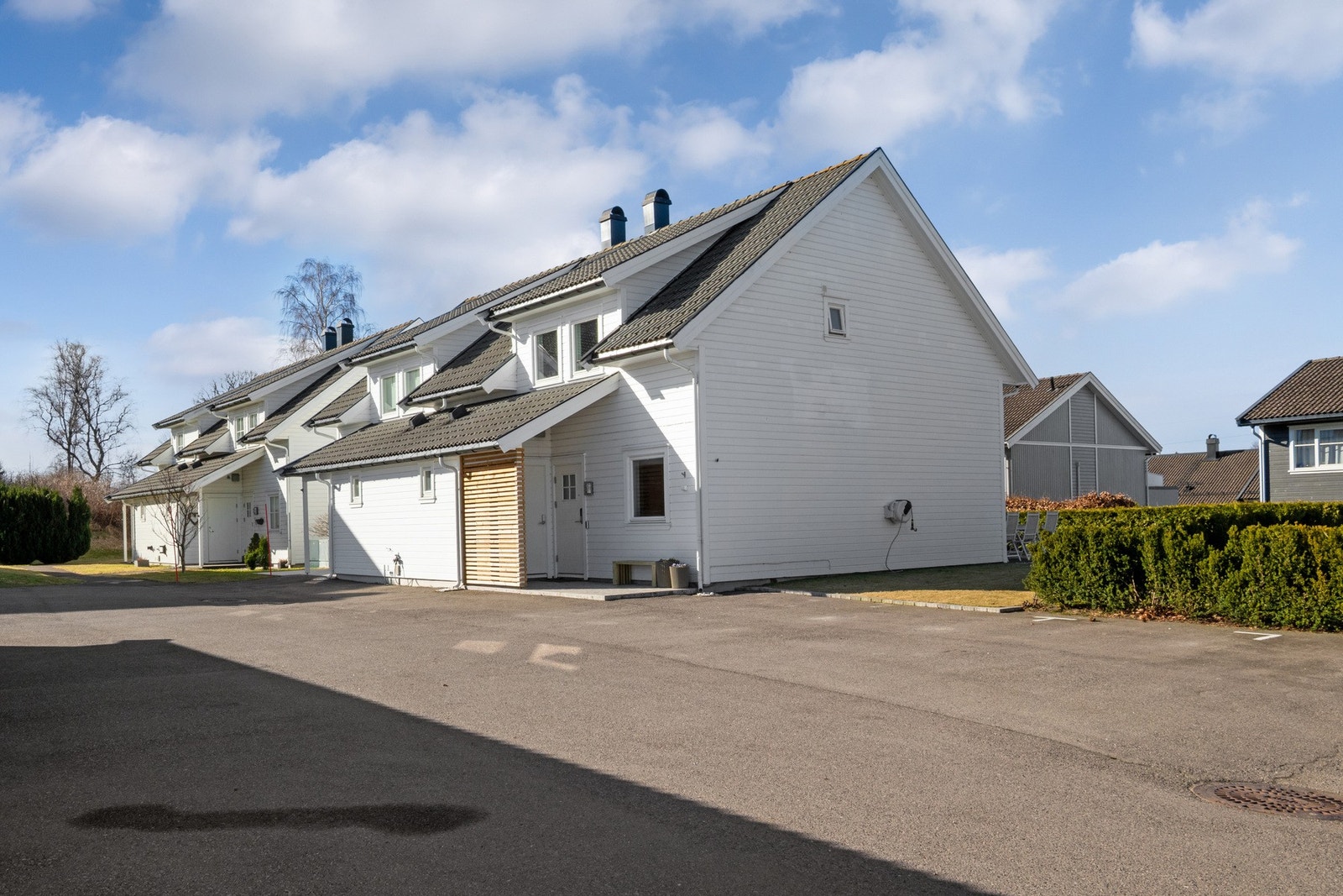 På eiendommens inngangsside er det en asfaltert biloppstillingsplass. Galleribilde