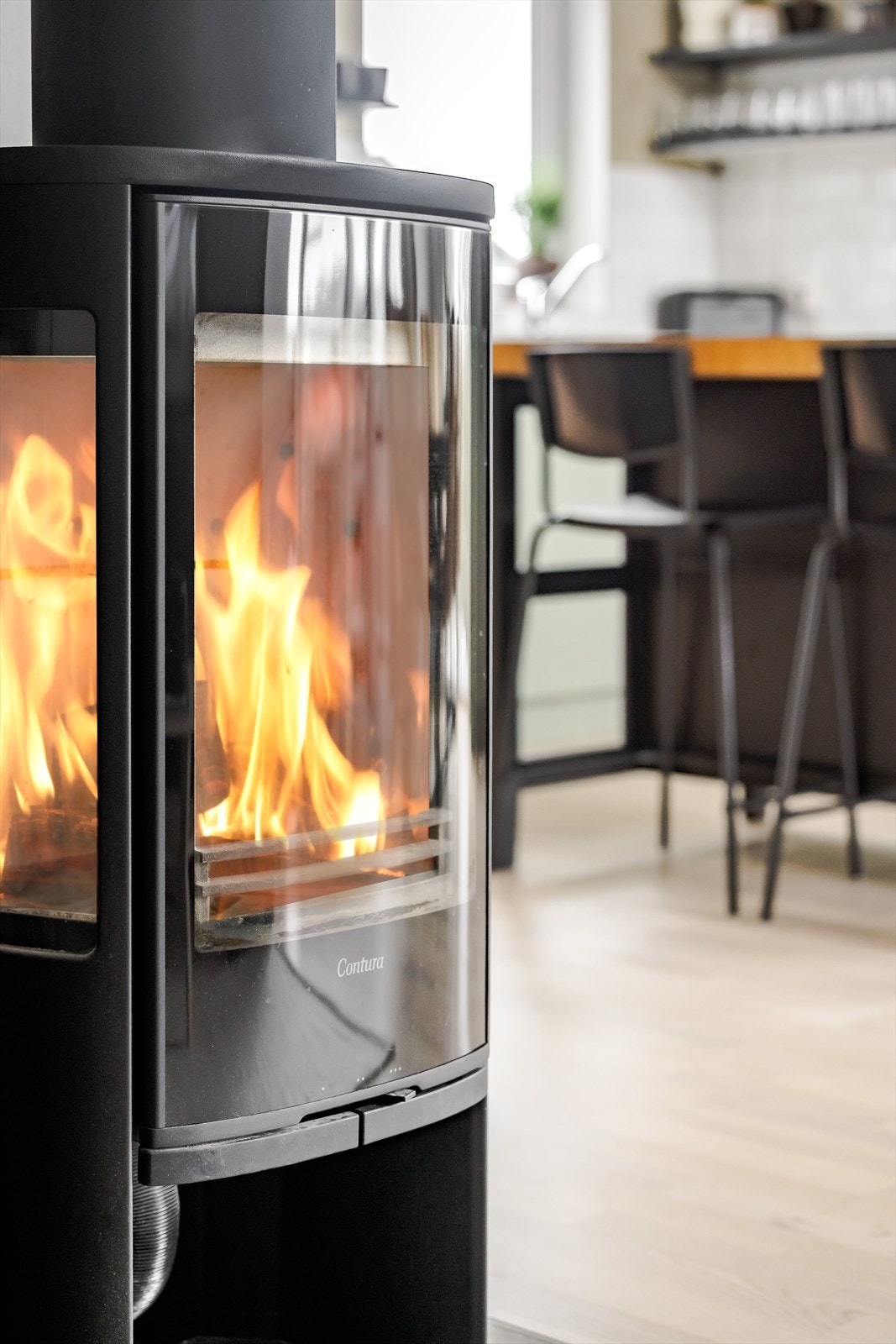 Som et fint midtpunkt i rommet er det en flott vedovn av type Contura som både gir god varme og bidrar til ekstra hygge. Galleribilde