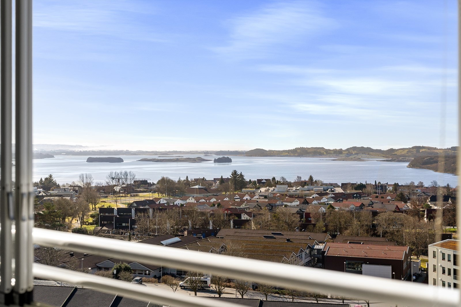 Utsikten strekker seg vidt, med glimt av sjøen i det fjerne. Galleribilde