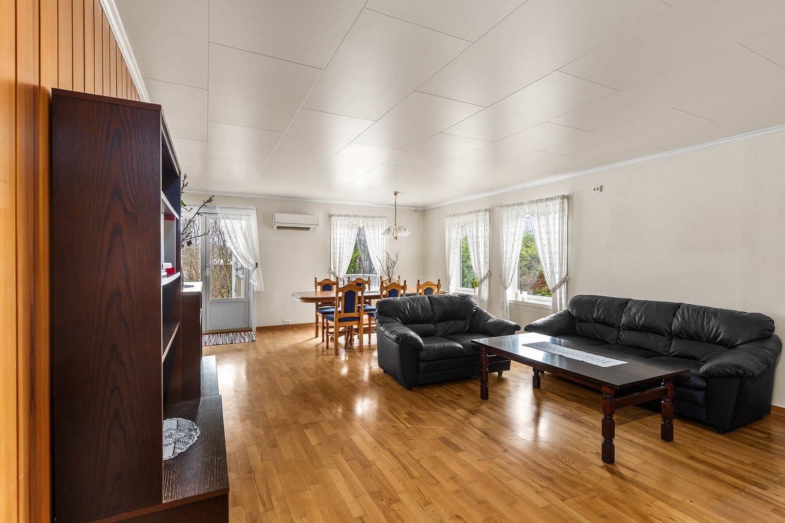 Stuen har store vindu som slipper inn godt med dagslys Galleribilde