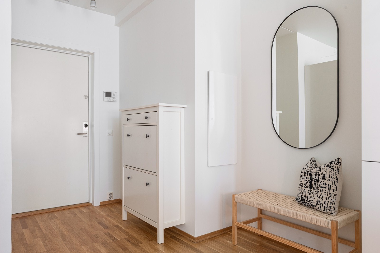 Innbydende entré med nyere porttelefon og oppbevaringsplass i garderobeskap. Galleribilde