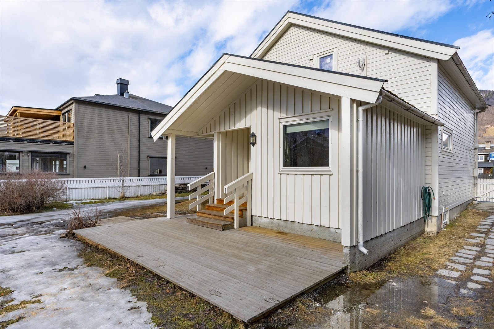 Ved inngangspartiet er det en terrasse som leder inn til en praktisk og innbydende entré. Galleribilde