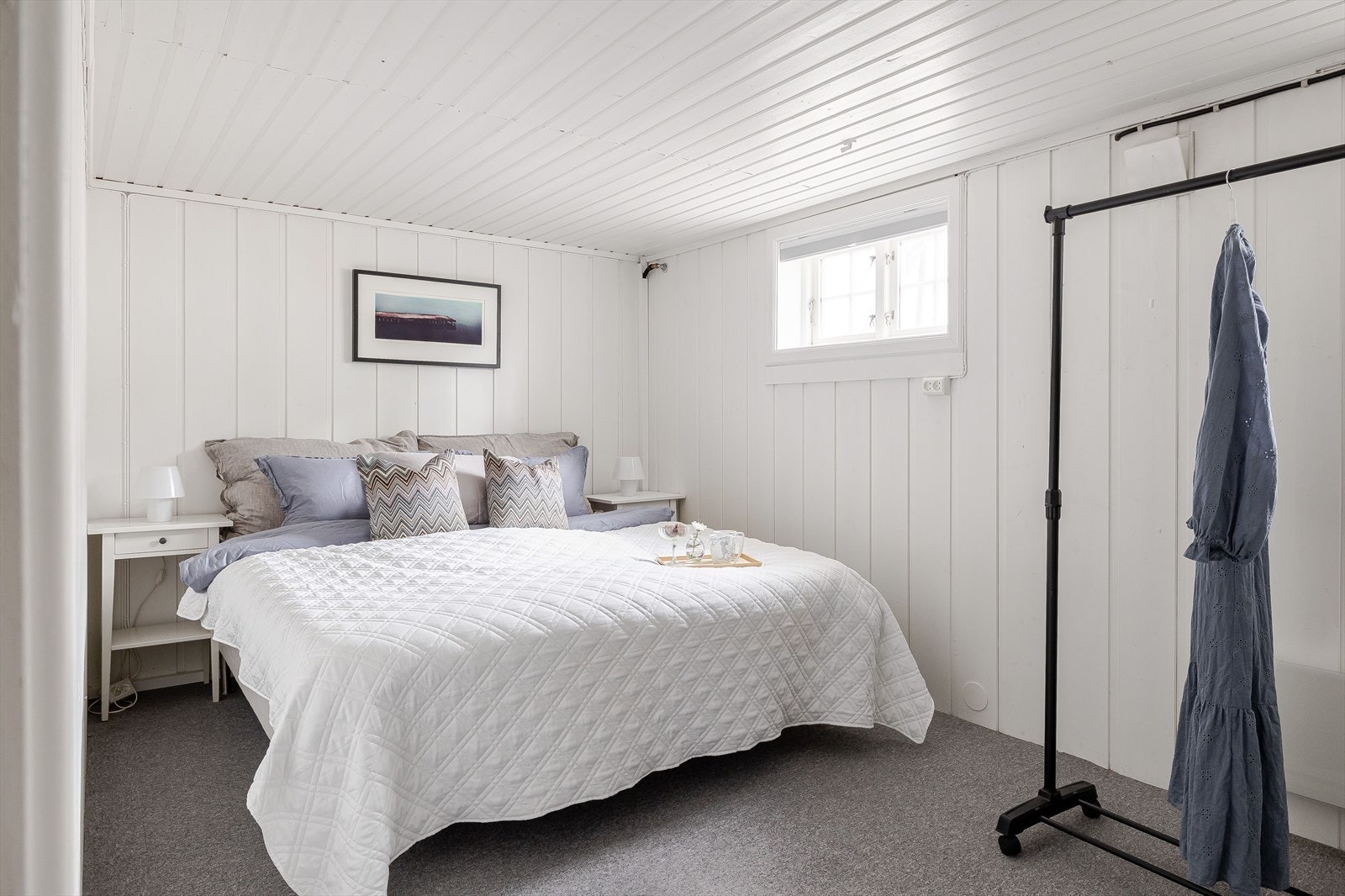 Rommet har lunt teppegulv og lysmalte overflater. Det er god plass til stor dobbeltseng med tilhørende nattbord, samt garderobeløsninger. Galleribilde