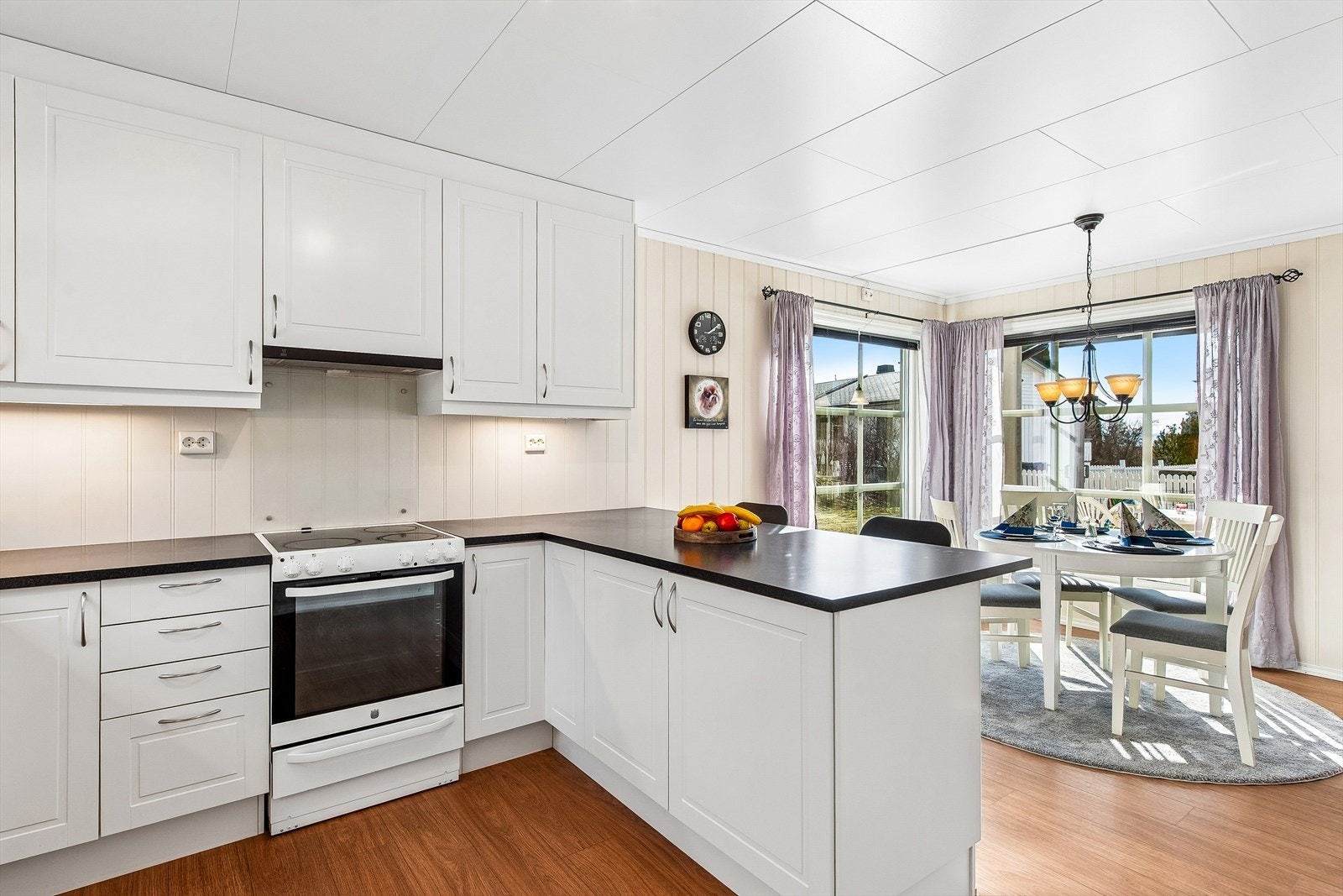 Kjøkkeninnredningen har klassiske, profilerte fronter og laminert benkeplate. Oppvaskmaskinen er integrert. Galleribilde