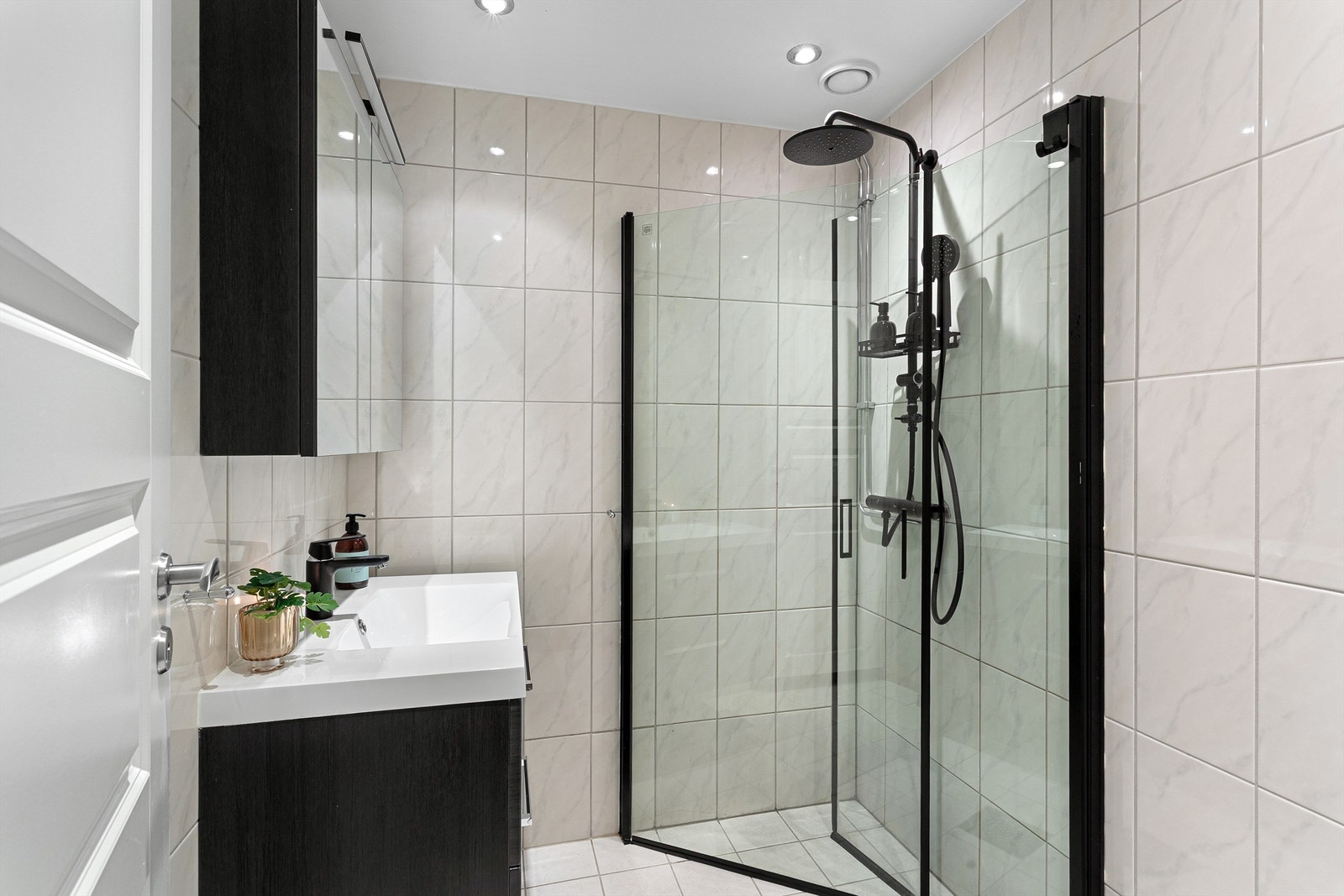 Badet ble oppgradert i 2020 med flislagte overflater, elektrisk gulvvarme og innfelte downlights i taket. Galleribilde