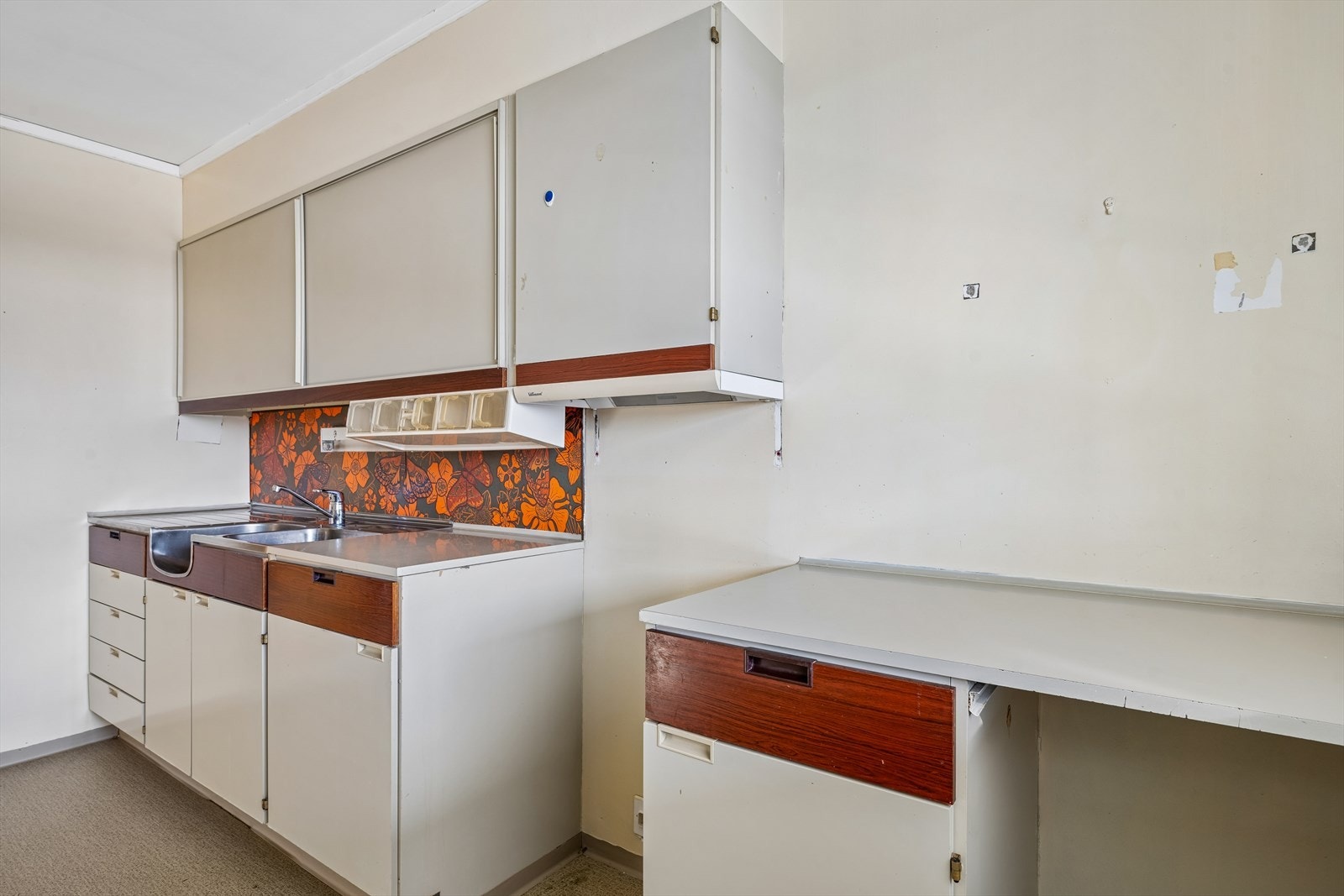 Kjøkkenet har innredning fra byggeåret og en skyvedør mot stuen. Galleribilde