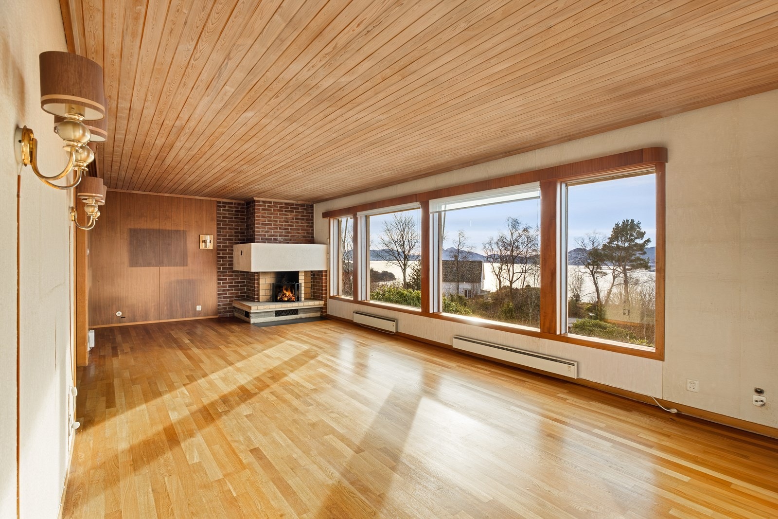 Hovedetasjen har en romslig stue med store vindusflater som åpner for en nydelig utsikt Galleribilde