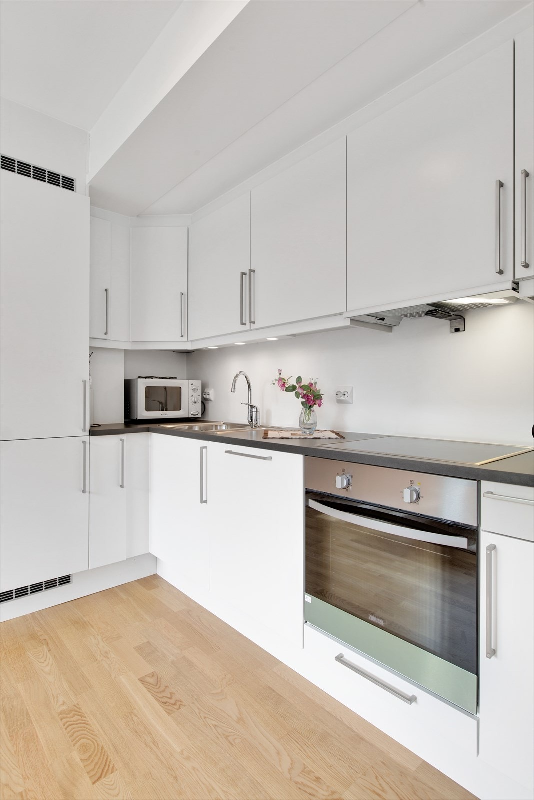 Kjøkkeninnredningen har slette fronter, laminert benkeplate og godt med skap- og benkeplass. Galleribilde